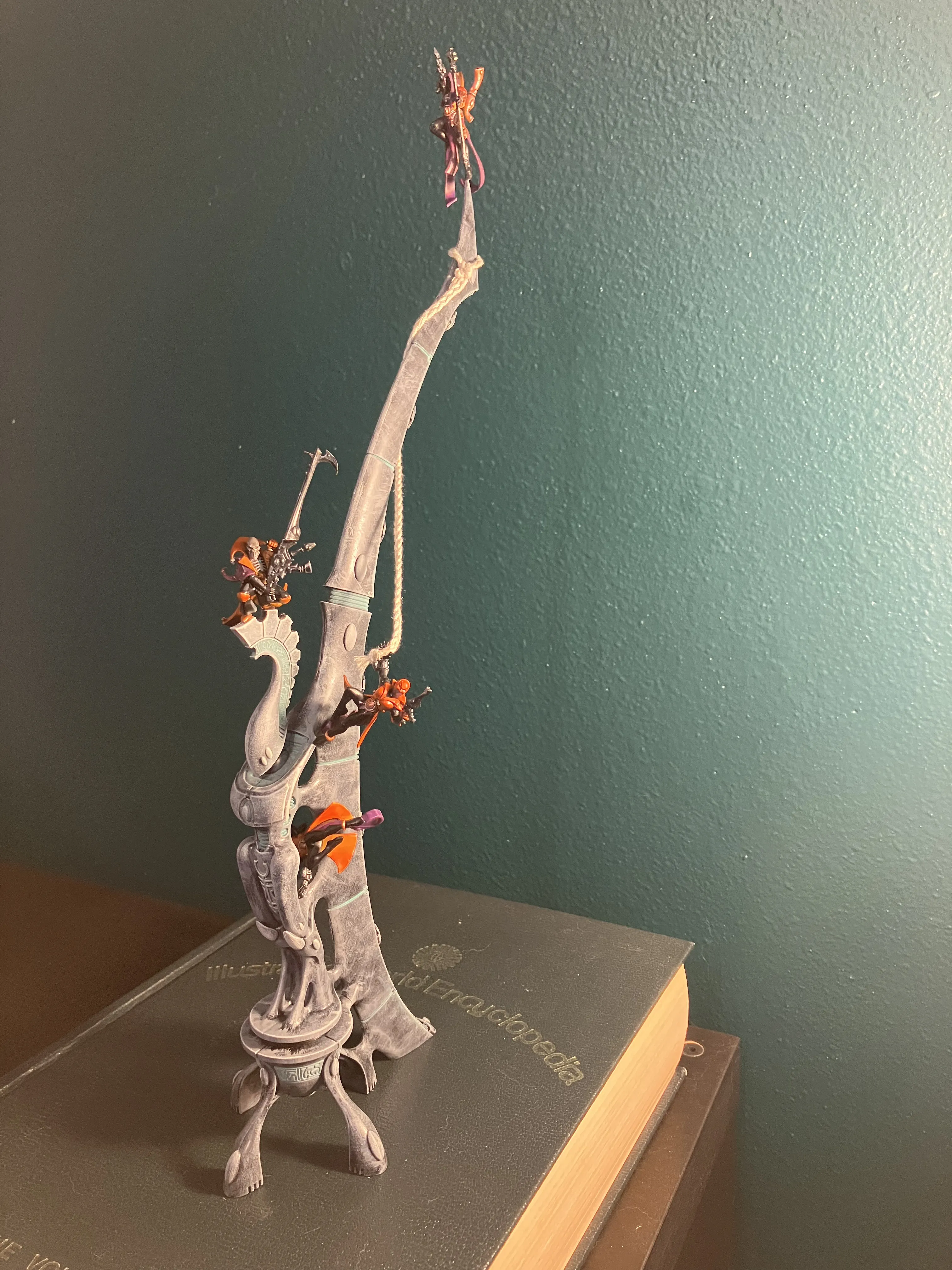 a diarama featuring a tall structure with several miniatures performing acrobatic feats